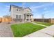 Two-story house with gray siding, stone accents, and a landscaped lawn at 22293 E 6Th Pl, Aurora, CO 80018