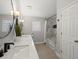 Well-lit bathroom features a double sink vanity, modern light fixtures, and tiled shower/tub at 345 Fillmore St # 407, Denver, CO 80206