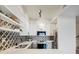 Modern kitchen with white cabinets and geometric backsplash at 345 Fillmore St # 407, Denver, CO 80206