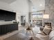 Open-concept living room featuring high ceilings, a modern fireplace, and a large window overlooking the neighborhood at 345 Fillmore St # 407, Denver, CO 80206