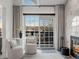 Cozy sitting area with stylish chairs, a small table, and a view of the outdoors near a modern fireplace at 345 Fillmore St # 407, Denver, CO 80206