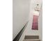 Stylish stairway featuring neutral colors, a modern light fixture, and a unique, colorful decorative wall hanging at 345 Fillmore St # 407, Denver, CO 80206