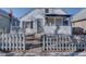 White house with gray fence and porch at 939 Knox Ct, Denver, CO 80204