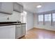 Eat-in kitchen with gray cabinets and wood floors at 939 Knox Ct, Denver, CO 80204