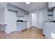 Simple kitchen featuring gray cabinets and wood floors at 939 Knox Ct, Denver, CO 80204