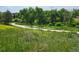 A park path meanders through a landscape of trees and greenery at 939 Knox Ct, Denver, CO 80204