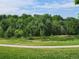 Image of a pond in a park setting, with a small dock and lush greenery at 939 Knox Ct, Denver, CO 80204