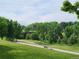 Park scenery, green grass, trees, a bridge, and walking path at 939 Knox Ct, Denver, CO 80204