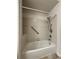Close-up of tub and shower with tile walls, hand rails and shower head at 804 Summer Hawk Dr # 5105, Longmont, CO 80504