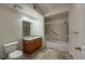 Bright bathroom featuring a tub with shower, a vanity with wood cabinets and a tile floor at 804 Summer Hawk Dr # 5105, Longmont, CO 80504