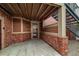 Entrance to unit #105 featuring brick accents, covered landing, and glass storm door at 804 Summer Hawk Dr # 5105, Longmont, CO 80504