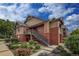 Exterior view of two-story home with brick accents and manicured landscaping at 804 Summer Hawk Dr # 5105, Longmont, CO 80504