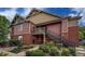 Close-up of a tan and brick condo complex with a second story landing and staircase at 804 Summer Hawk Dr # 5105, Longmont, CO 80504
