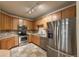 Bright kitchen with stainless steel appliances, including a range, microwave, dishwasher, and refrigerator at 804 Summer Hawk Dr # 5105, Longmont, CO 80504
