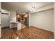 Open-concept living and dining area with wood floors and a view of the kitchen with stainless steel appliances at 804 Summer Hawk Dr # 5105, Longmont, CO 80504