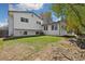 Backyard with green grass and gray exterior elevation at 1309 Alexandria St, Lafayette, CO 80026
