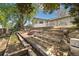 Landscaped backyard featuring brick patio, garden beds and mature trees at 1309 Alexandria St, Lafayette, CO 80026