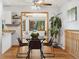 Cozy dining area with hardwood floors, a round glass table with four chairs, and a view into the living room at 1309 Alexandria St, Lafayette, CO 80026