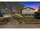 Charming two-story home with a manicured lawn, rock garden, blue front door, and a spacious two-car garage at 1309 Alexandria St, Lafayette, CO 80026