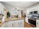 Bright kitchen with granite countertops, white cabinets, and stainless steel appliances at 1309 Alexandria St, Lafayette, CO 80026