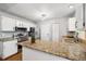 Bright kitchen featuring granite countertops, modern appliances, and ample cabinet space at 1309 Alexandria St, Lafayette, CO 80026