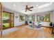 Bright living room with hardwood floors, a ceiling fan, and access to the backyard at 1309 Alexandria St, Lafayette, CO 80026