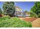 Large backyard with mature landscaping and trampoline at 16084 Stonebriar Dr, Parker, CO 80134