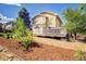 Beautiful backyard with a lush garden, a wooden deck, and mature trees at 16084 Stonebriar Dr, Parker, CO 80134