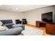 Spacious basement featuring a seating area, desk, and entertainment center at 16084 Stonebriar Dr, Parker, CO 80134