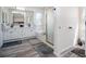 Bright bathroom boasts dual sinks, a glass shower, a soaking tub and modern fixtures at 16084 Stonebriar Dr, Parker, CO 80134