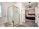 Bathroom boasts a bathtub and shower with a glass door with views into the primary bedroom at 16084 Stonebriar Dr, Parker, CO 80134