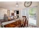 Bright dining room with wood table and access to outdoor patio at 16084 Stonebriar Dr, Parker, CO 80134