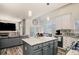 Open kitchen with granite counters, center island, pendant lights, and stainless appliances at 16084 Stonebriar Dr, Parker, CO 80134