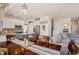 Open kitchen with white cabinets, mosaic backsplash, and stainless appliances at 16084 Stonebriar Dr, Parker, CO 80134