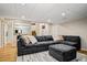 Comfortable living room with a large gray sectional sofa, ottoman, neutral rug, and a decorative mirror at 16084 Stonebriar Dr, Parker, CO 80134