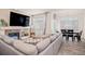 Bright living room features a fireplace, large windows, and hardwood floors with an open dining area at 16084 Stonebriar Dr, Parker, CO 80134