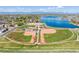 Aerial view showcasing the baseball field, lake, parking area and recreational park in a vibrant community at 5292 Columbine Ln, Denver, CO 80221