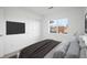 Cozy bedroom with a mounted TV, closet and a bright window at 5292 Columbine Ln, Denver, CO 80221