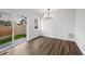 Bright dining area with a modern chandelier and direct access to the backyard at 5292 Columbine Ln, Denver, CO 80221