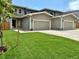 New home exterior features a well-manicured lawn, two car garage, and neutral paint at 5292 Columbine Ln, Denver, CO 80221