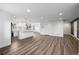 Spacious living room showcasing open floor plan and hardwood floors flowing into the modern kitchen at 5292 Columbine Ln, Denver, CO 80221