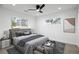 Comfortable main bedroom with neutral tones, a ceiling fan, and natural light streaming in from large windows at 5292 Columbine Ln, Denver, CO 80221