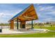 Charming pavilion with a sturdy roof, surrounded by manicured lawns and trees by the lake at 5292 Columbine Ln, Denver, CO 80221
