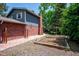Backyard garden beds, brick patio and exterior view of the brick and blue painted home at 6360 S Kendall St, Littleton, CO 80123