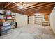 Unfinished basement with exposed wood beams, concrete floor, and ample storage space at 6360 S Kendall St, Littleton, CO 80123