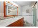Bathroom with a tile backsplash, cherry cabinet and modern shower with glass doors at 6360 S Kendall St, Littleton, CO 80123