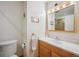 Bathroom with a vanity and mirror cabinet, and a walk-in shower with tile surround at 6360 S Kendall St, Littleton, CO 80123
