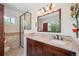 Bathroom featuring a glass shower and granite countertop at 6360 S Kendall St, Littleton, CO 80123