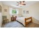 Cozy bedroom featuring a ceiling fan, bright window, and stylish blue patterned rug at 6360 S Kendall St, Littleton, CO 80123