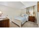 Bedroom with carpet flooring, neutral colored walls, with two dressers and natural light at 6360 S Kendall St, Littleton, CO 80123